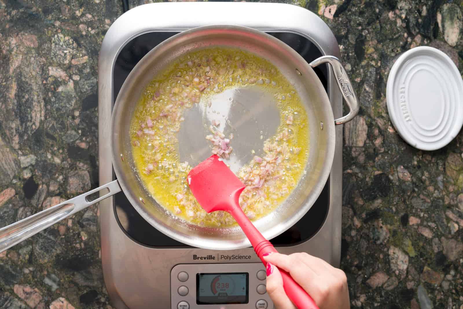 Sautéing shallots in olive oil and butter on a hot pan