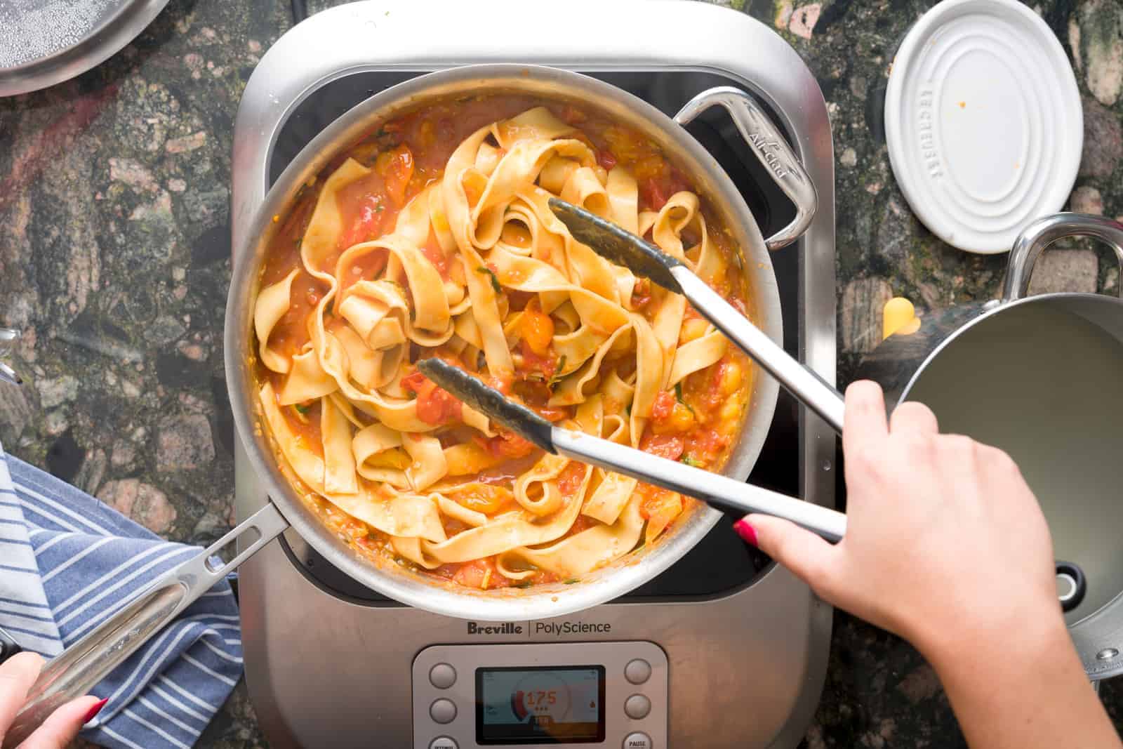 Making fresh tomato sauce - adding the fresh pasta to the pasta sauce 