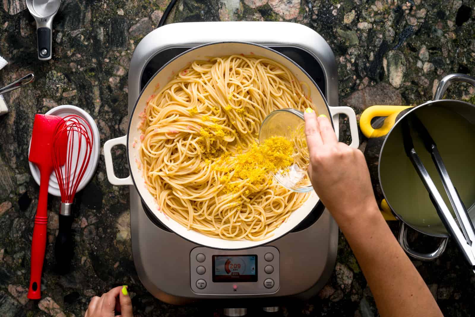 Pasta al limone - adding lemon zest to pan with lemon sauce.