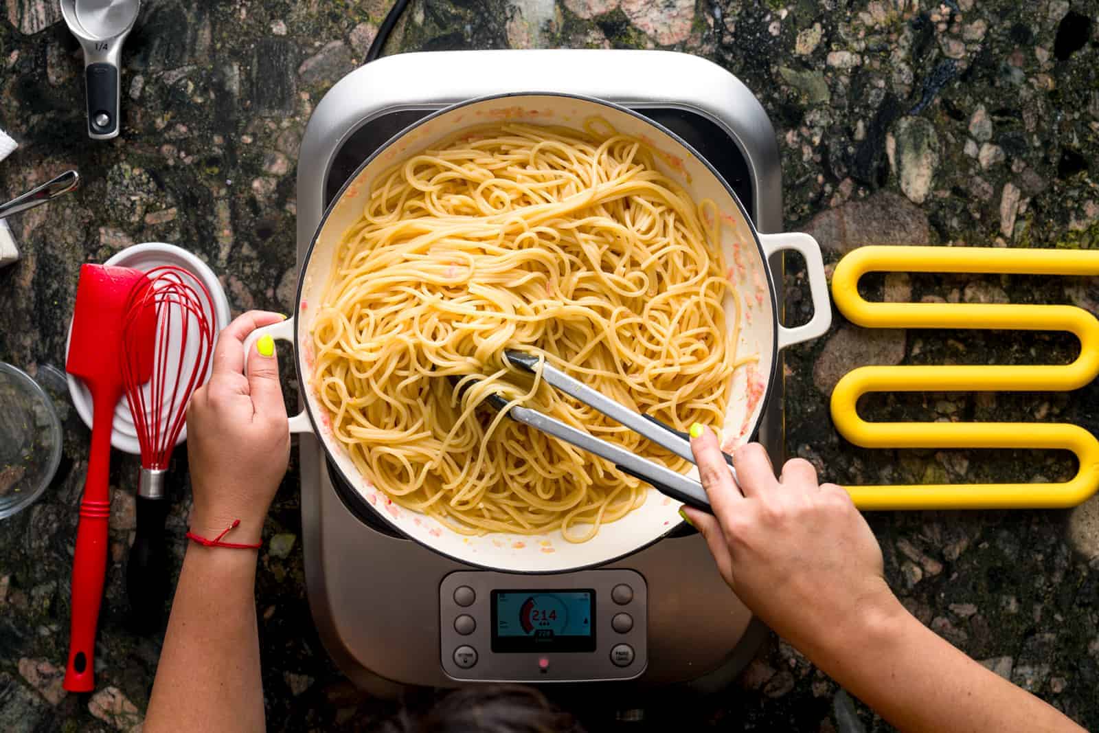 Pasta al limone - pasta being tossed in pan with lemon sauce.