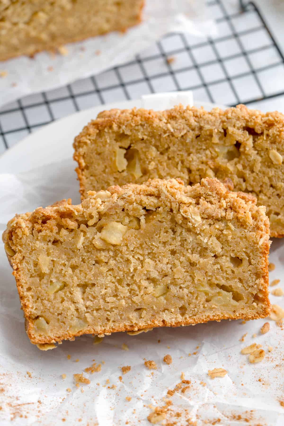 Close up shot of maple apple cake slices, topped with oatmeal streusel.
