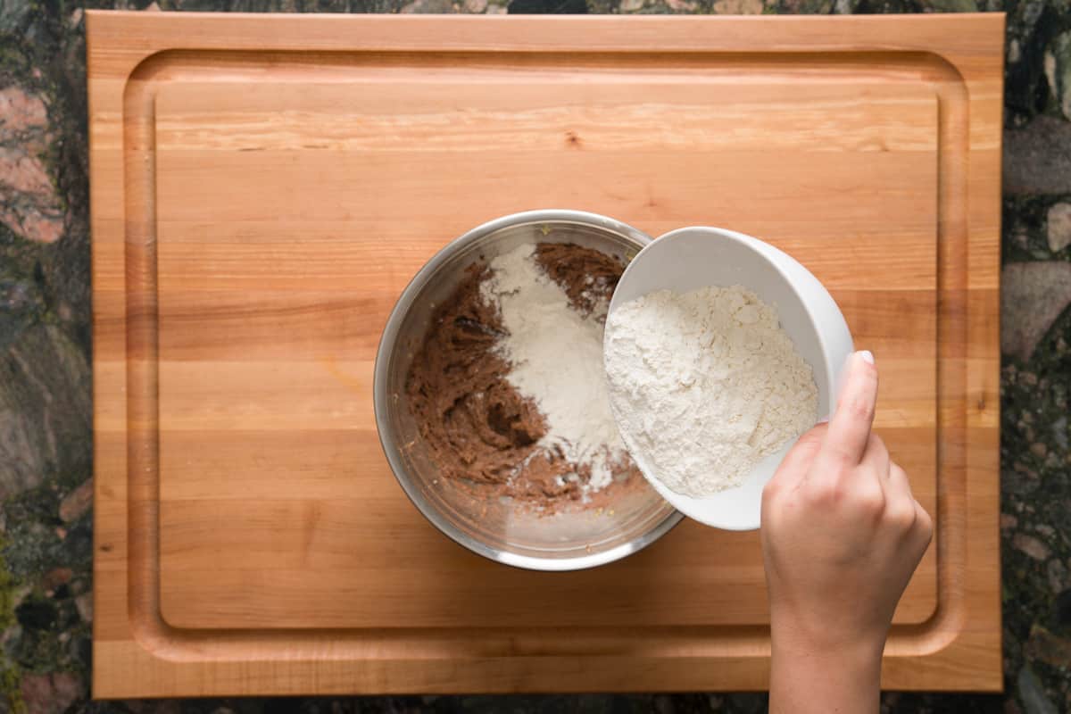 Gradually adding all-purpose flour into the mini tiramisu cookie dough.