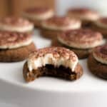 Bite taken out of tiramisu cookies with mascarpone cheese frosting