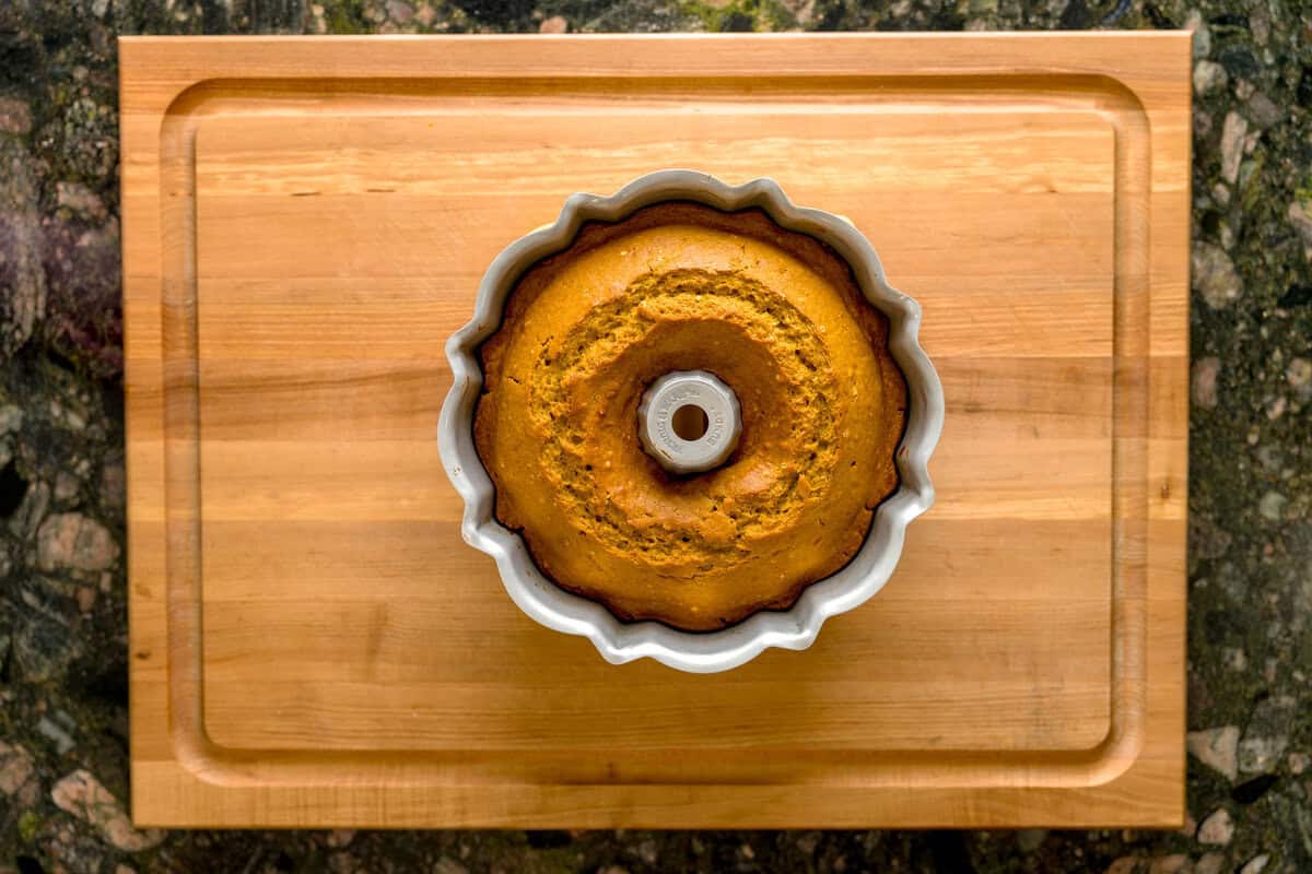 An overhead view of a baked pumpkin spice cake in a Bundt cake pan.