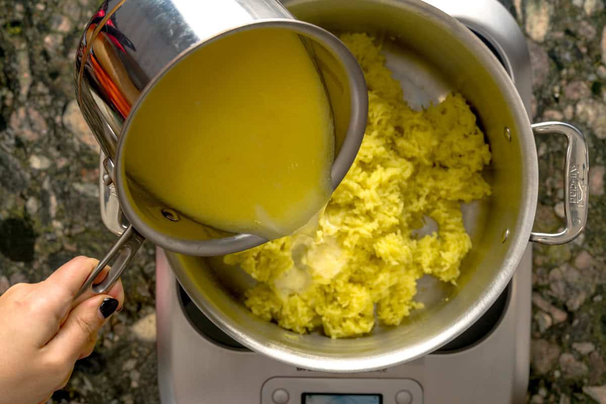 Overhead shot of milk and butter mixture for creamy mashed potatoes.