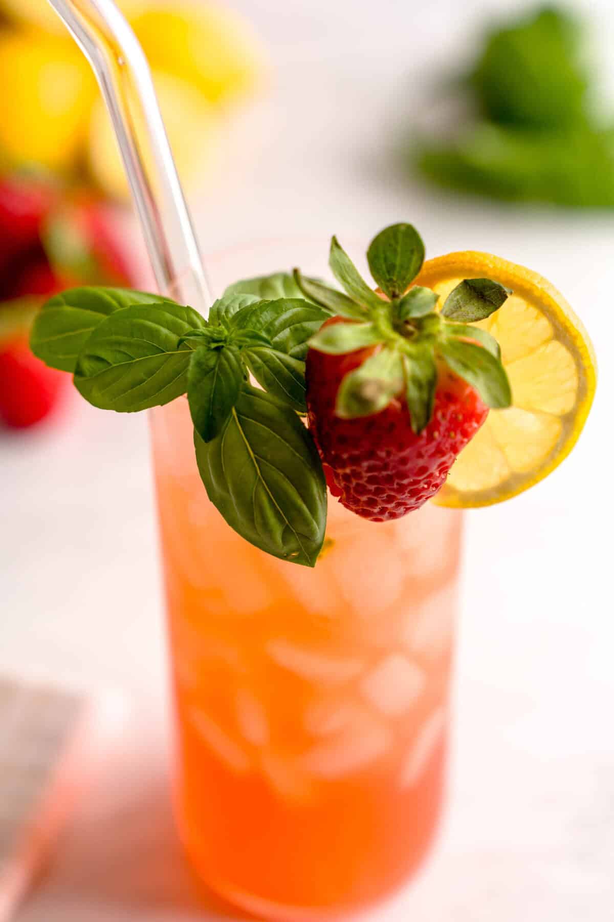 Close up shot of a glass of strawberry basil lemonade.