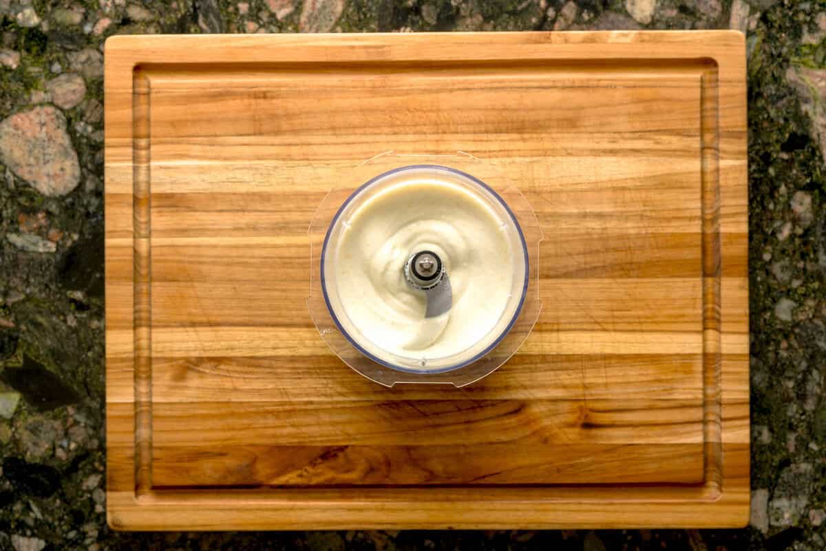 Overhead shot of whipped ricotta in food processor.
