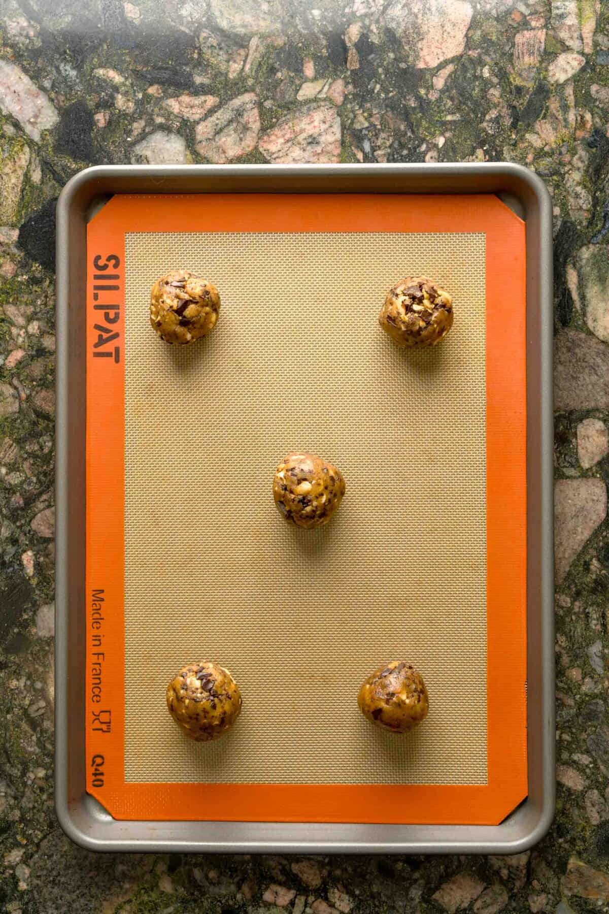 Brown butter chocolate chip cookie dough rolled into balls before baking.