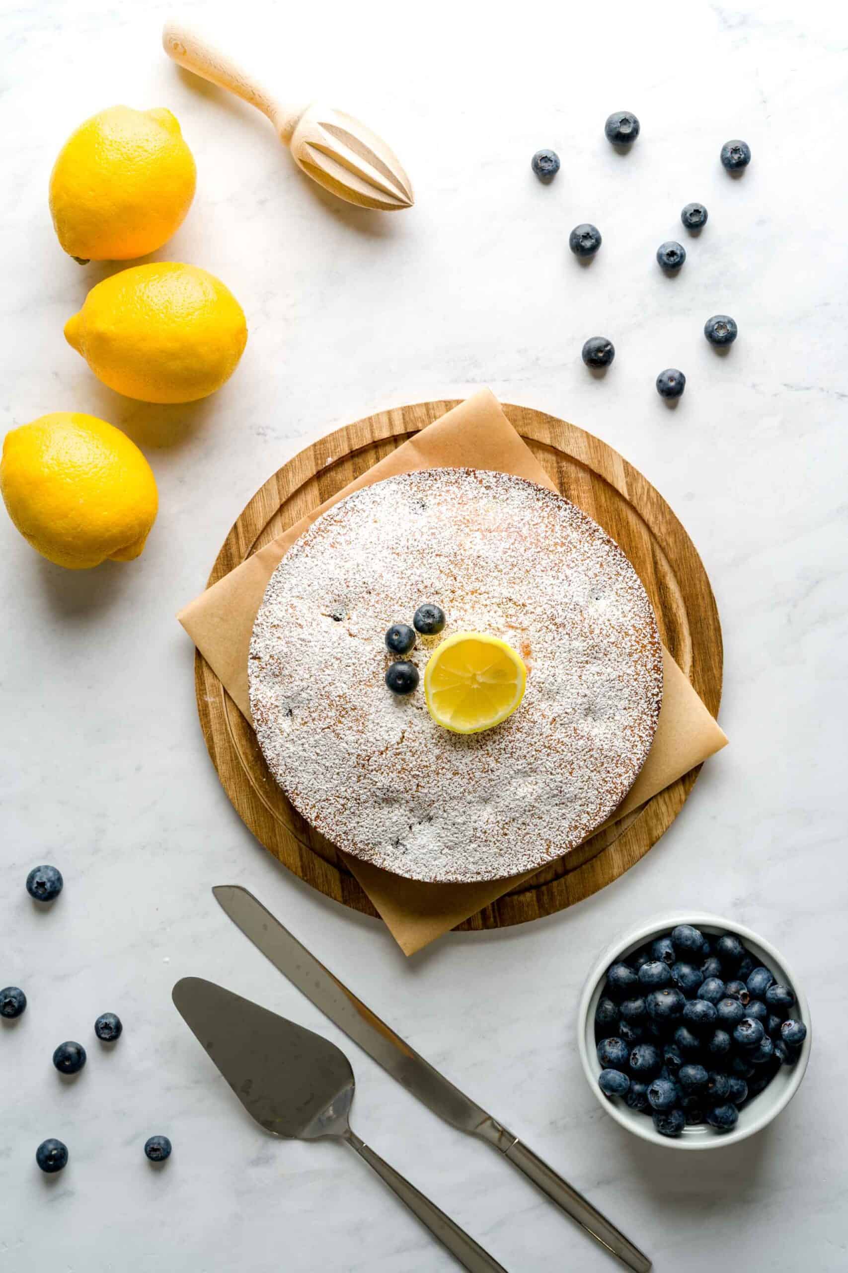 Overhead shot of Italian-inspired olive oil cake with lemon and blueberries.