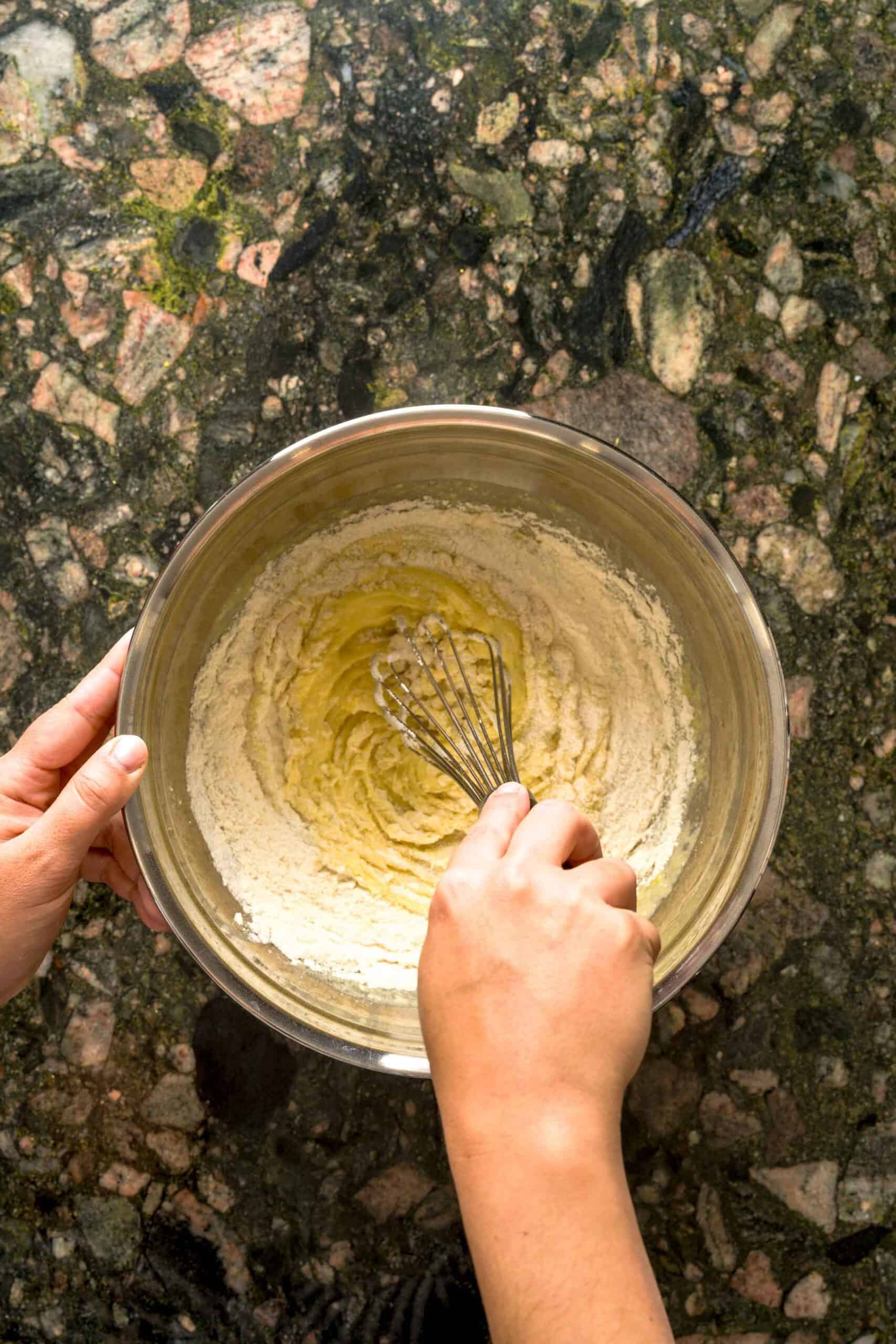 Whisking dry ingredients into wet ingredients for no butter lemon cake.
