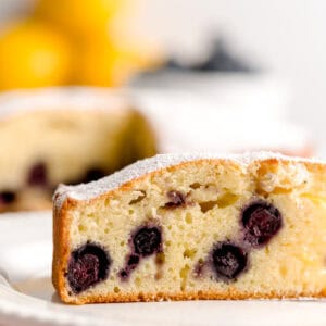 Italian olive oil cake slice with lemon and blueberries.