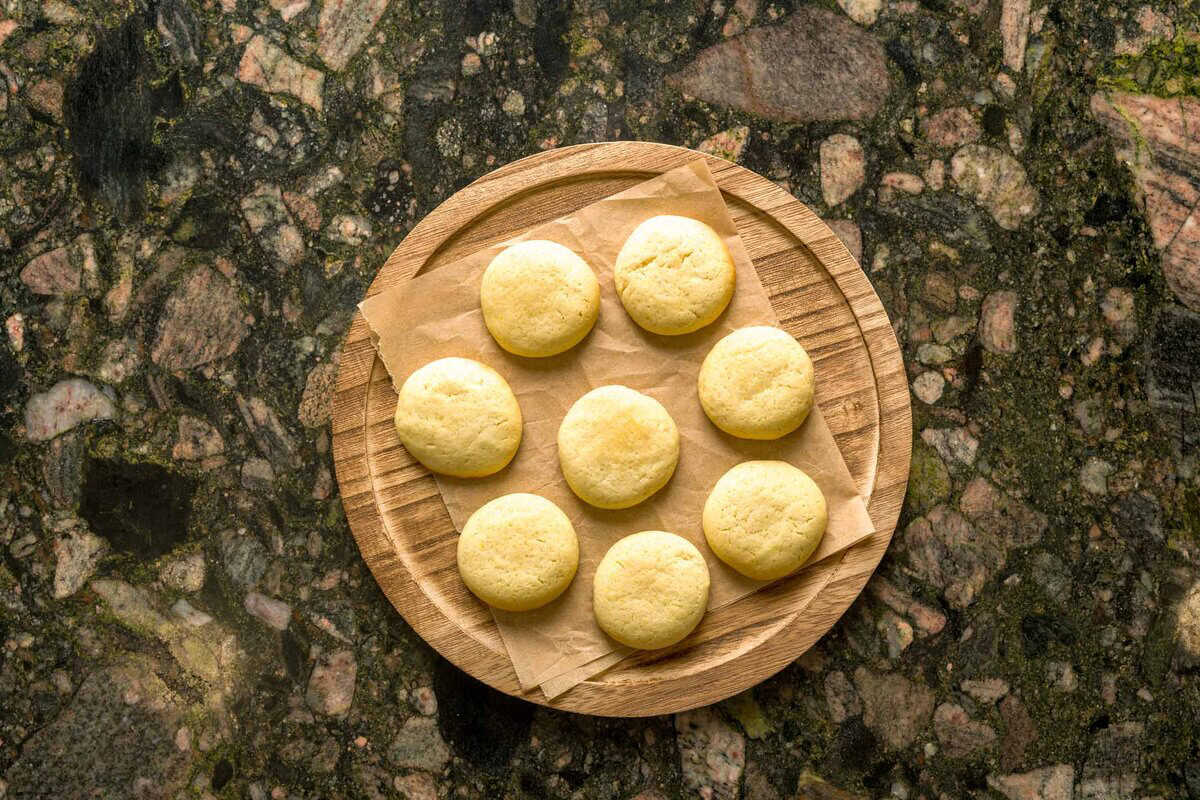 Baked lemon ricotta cookies assembled on a plate.