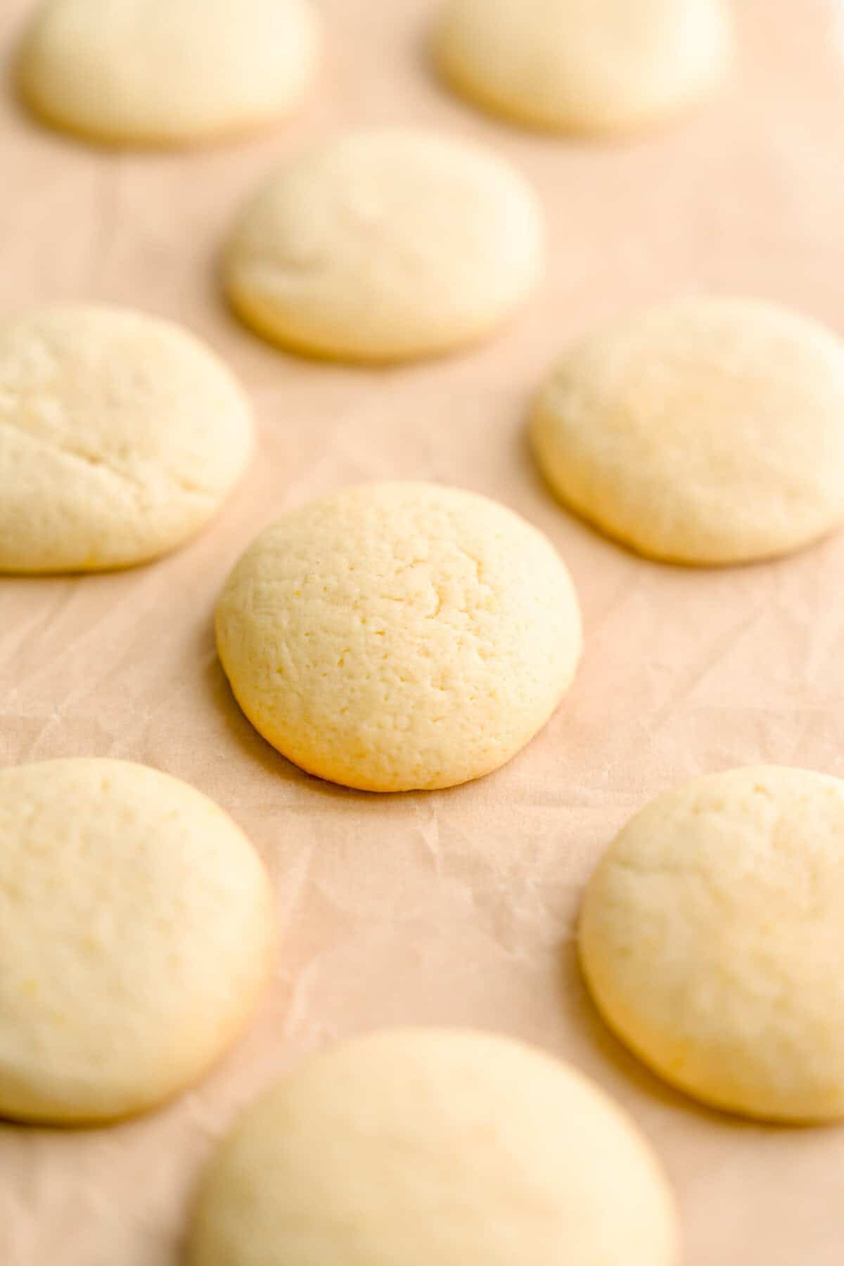 No-glaze lemon ricotta cookies cooling on parchment paper.