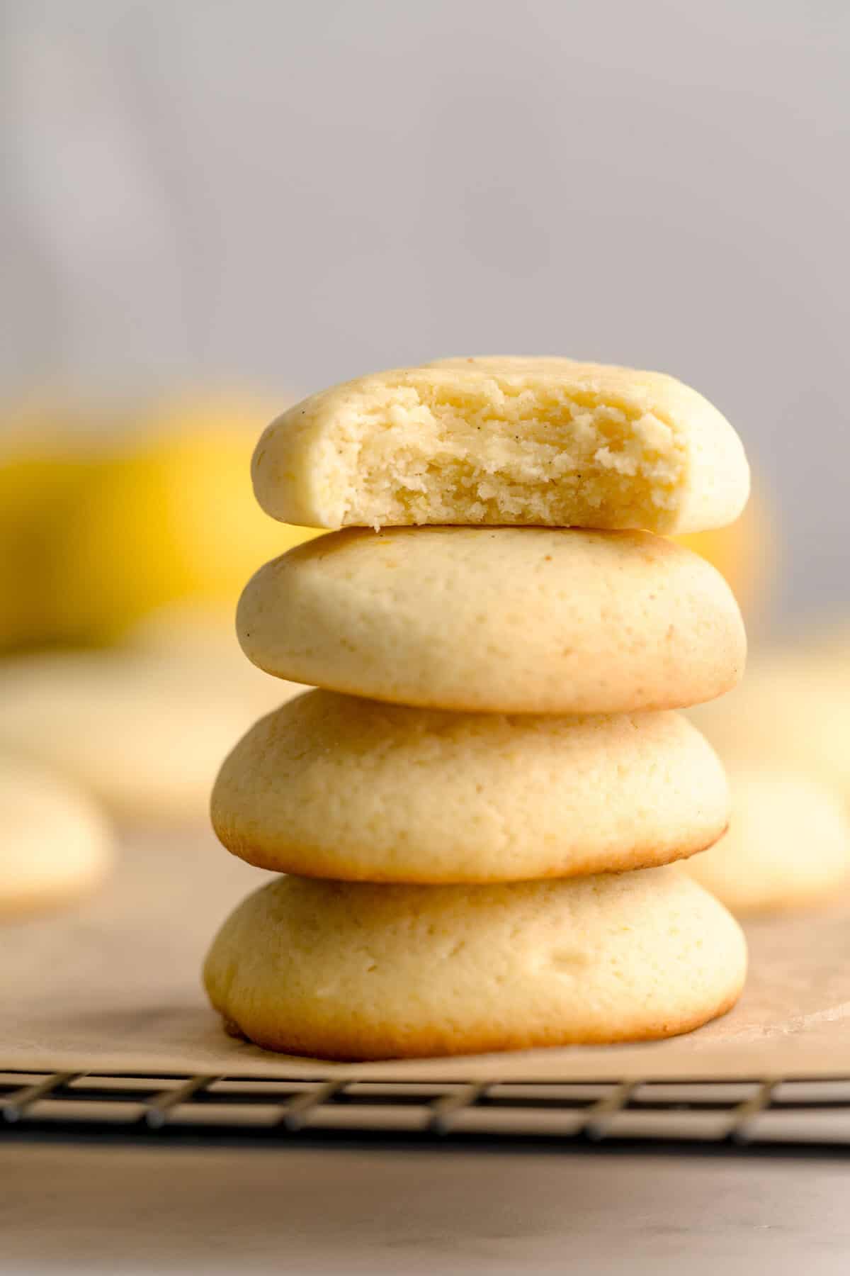Soft lemon ricotta cookies stacked on top of one another.