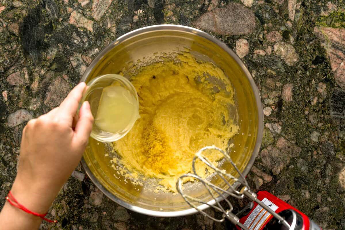 Adding lemon juice to Italian ricotta cookie dough.