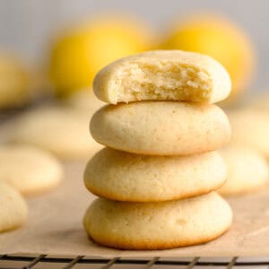 Soft lemon ricotta cookies stacked on top of one another.