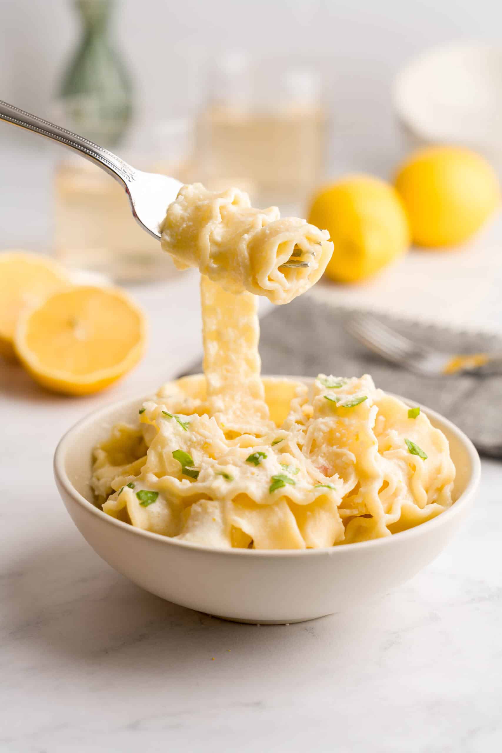 Bowl of lemon pasta with cream and parmesan cheese.