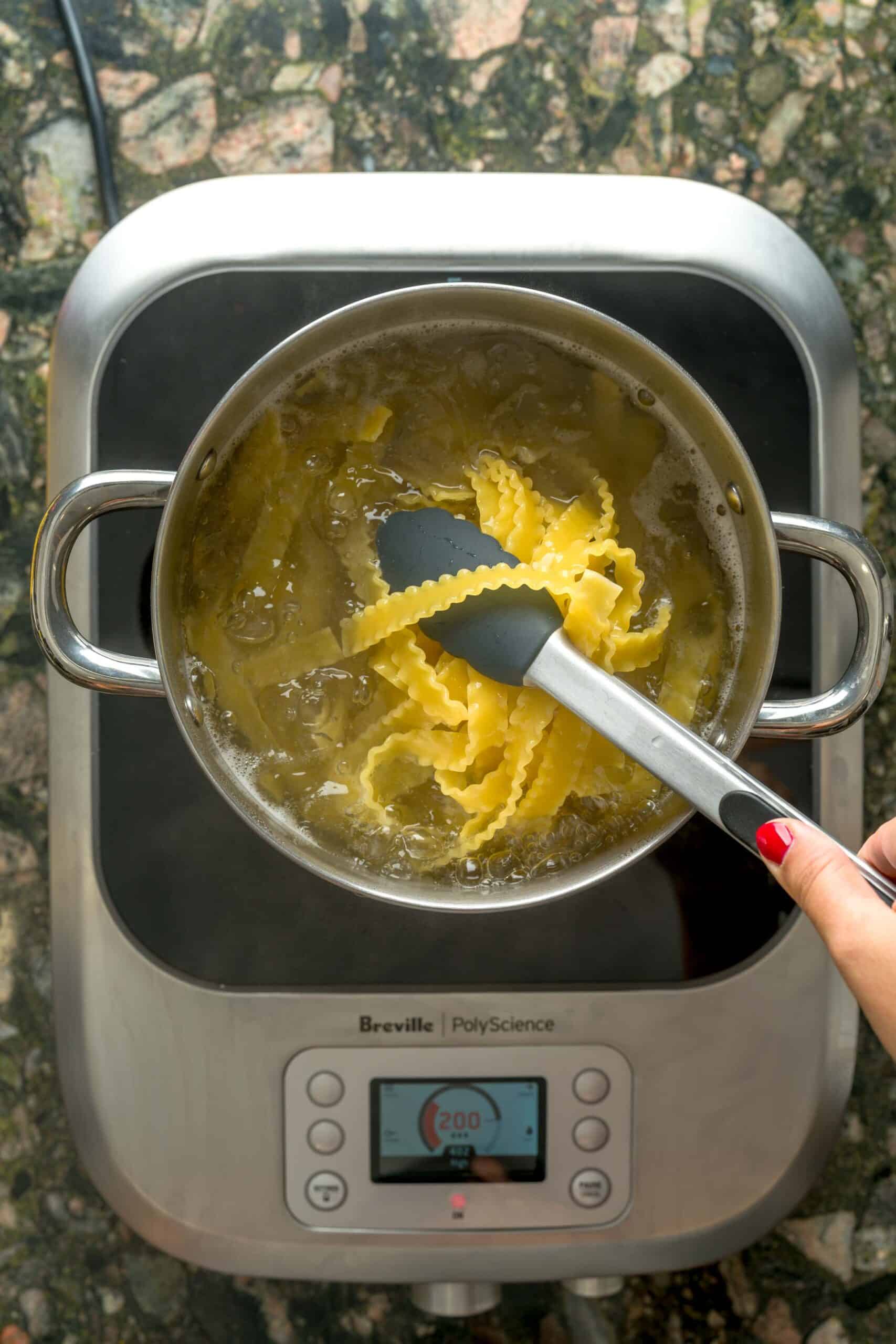Cooking pasta for pasta al limone.