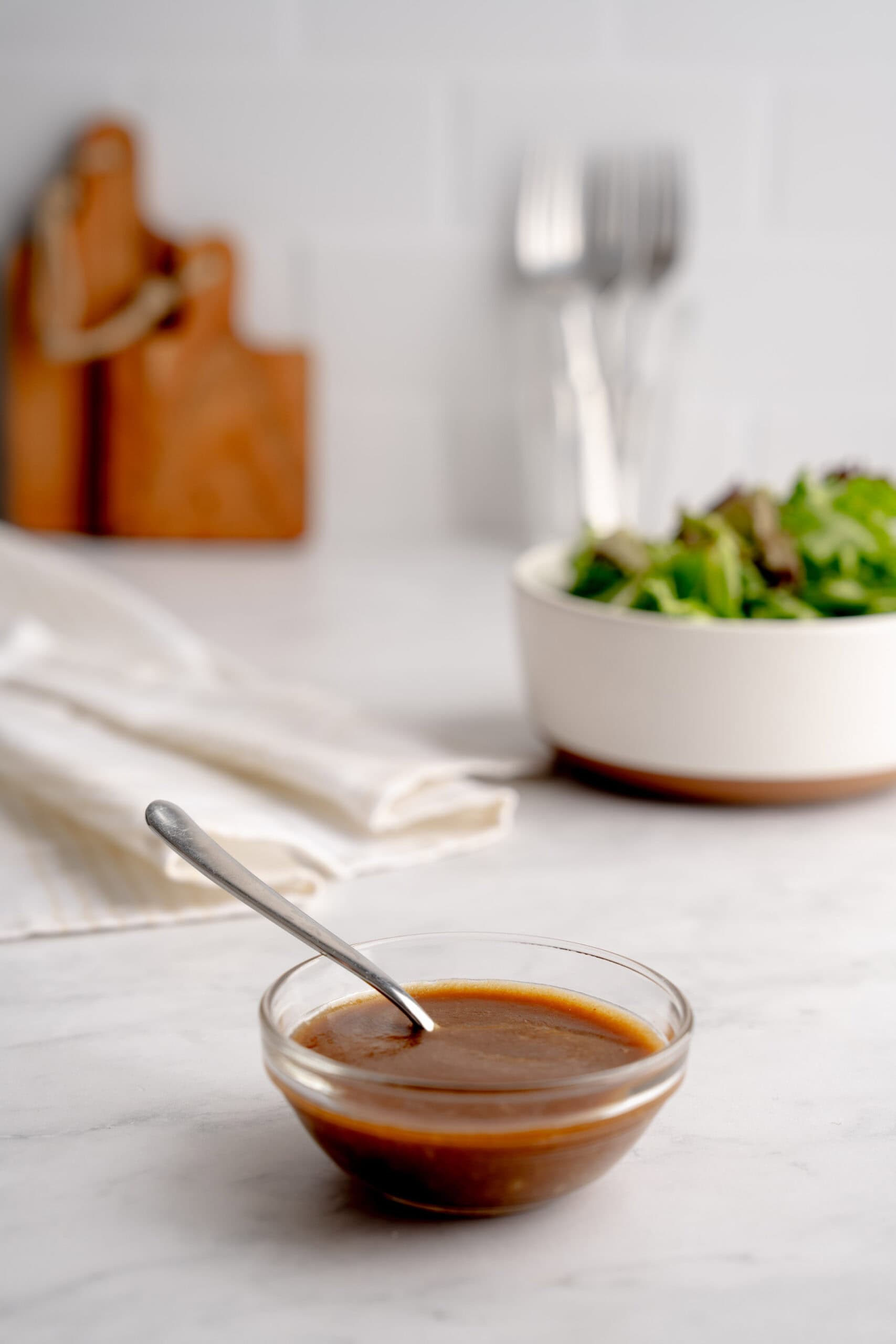 Easy balsamic salad dressing in front of a salad.