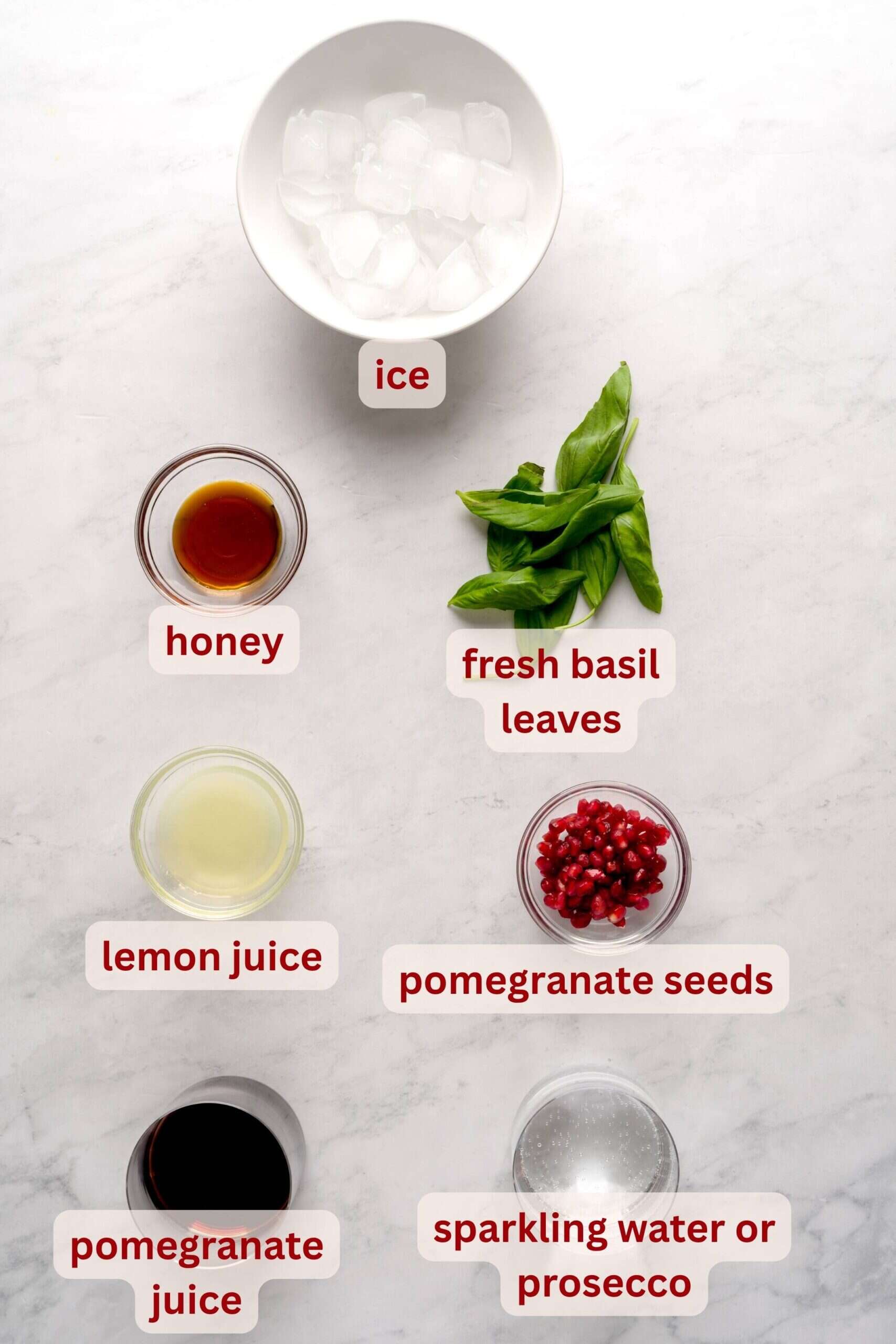Ingredients needed to make pomegranate basil fizz mocktail or cocktail.
