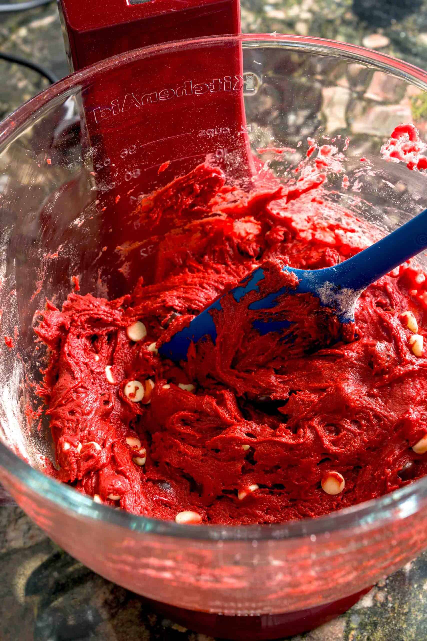 Mixing batter for red velvet biscotti with chocolate chips