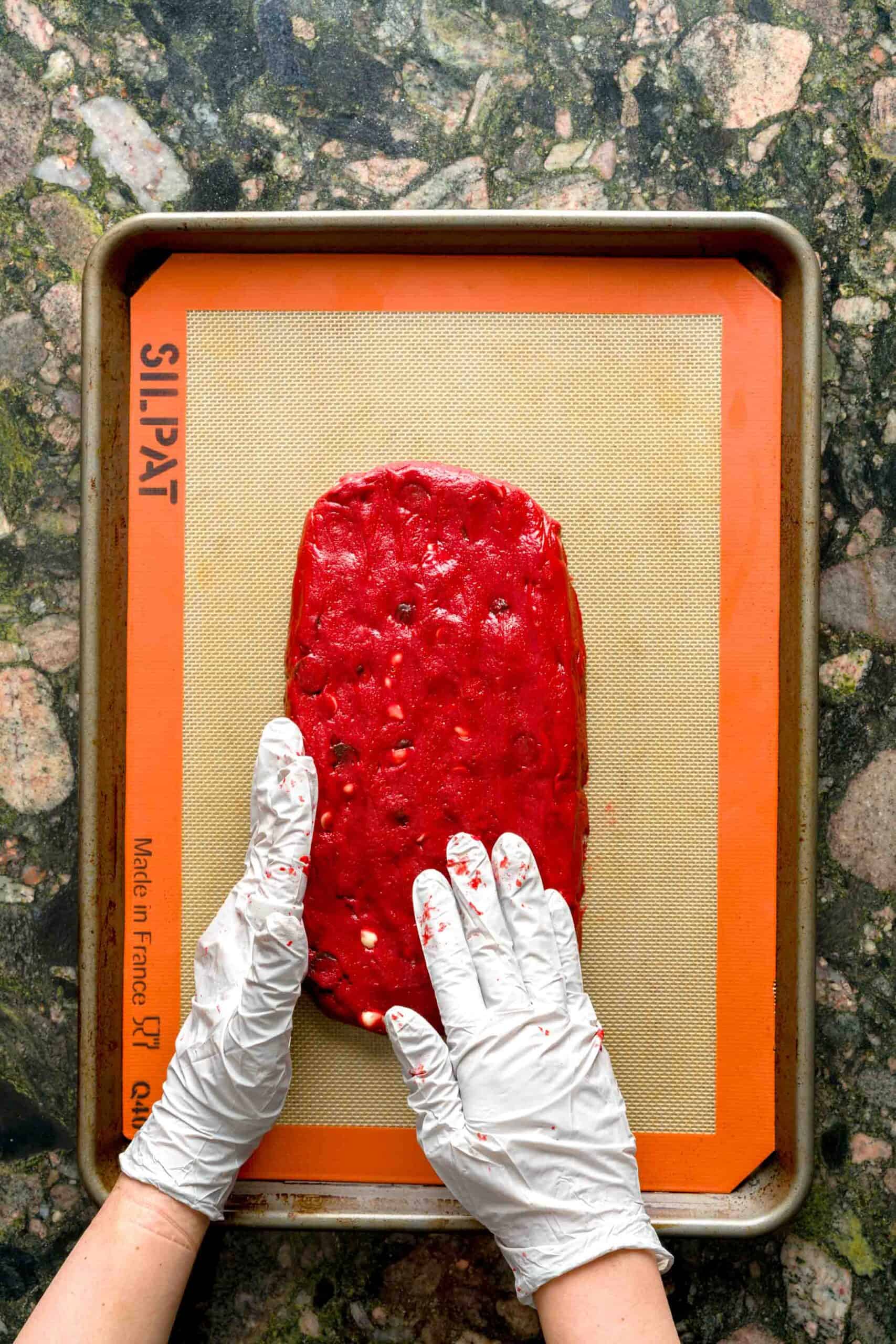 Shaping cookie log with hands for red velvet Italian biscotti