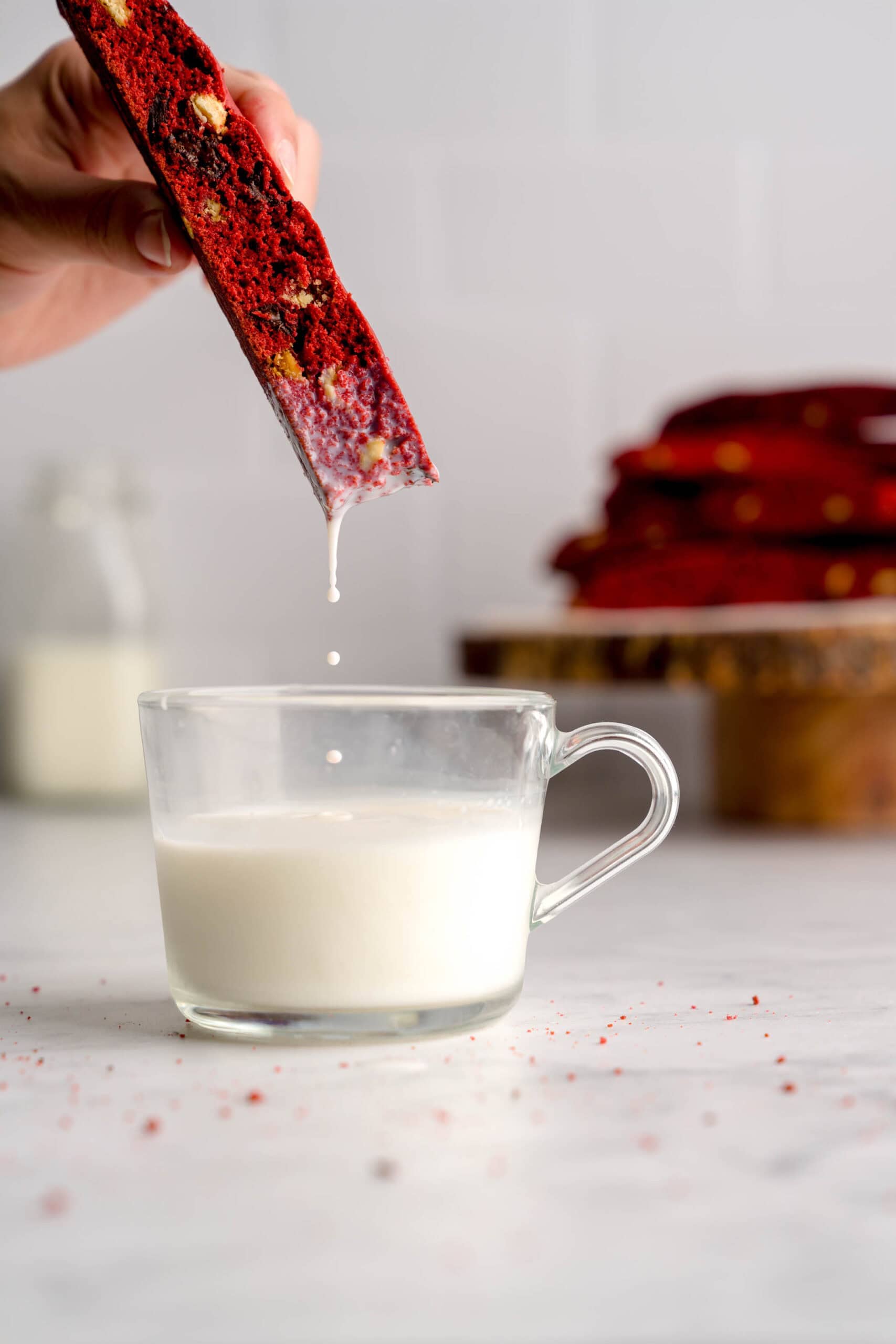 Red velvet biscotti dunked in milk