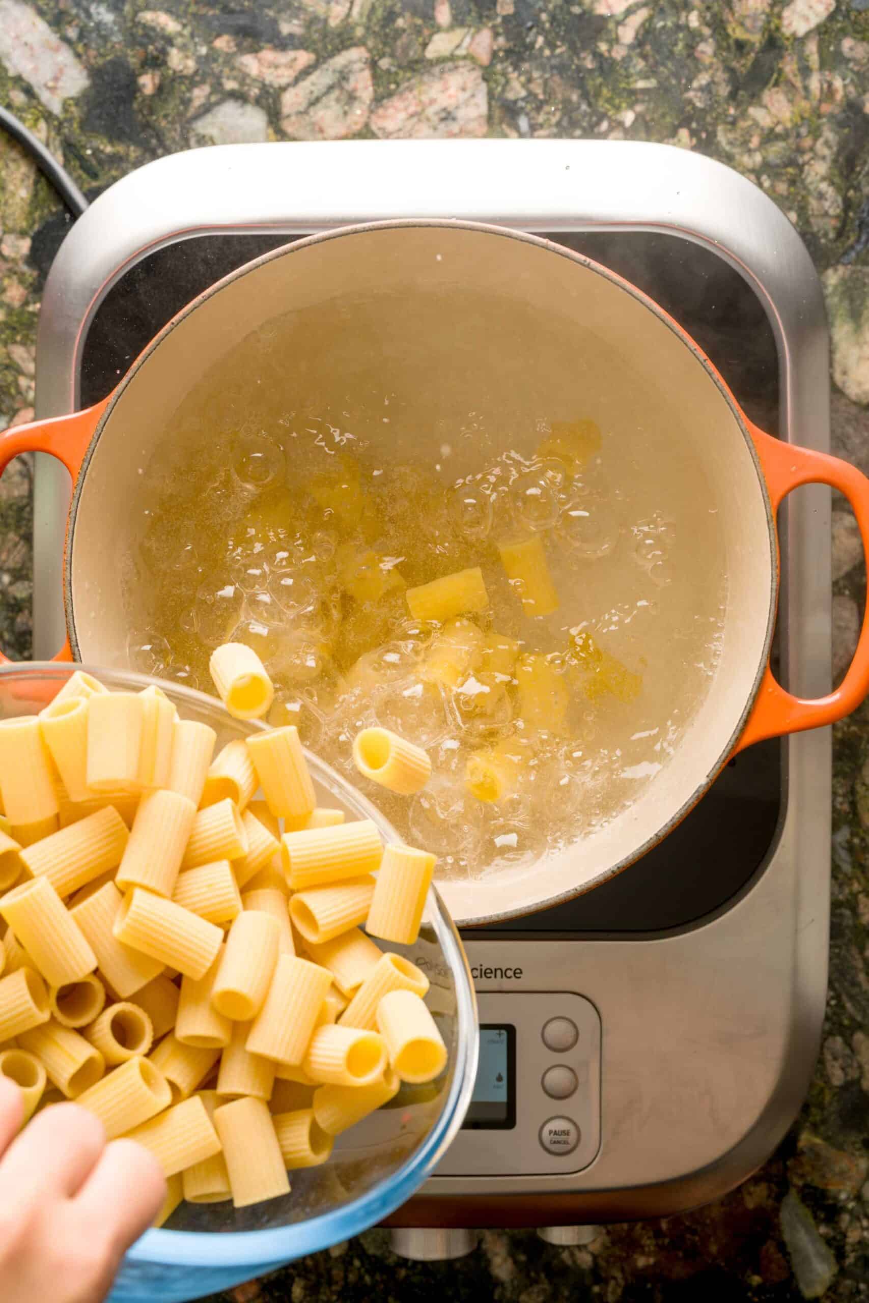 Boiling rigatoni in a large pot for creamy vodka pasta.