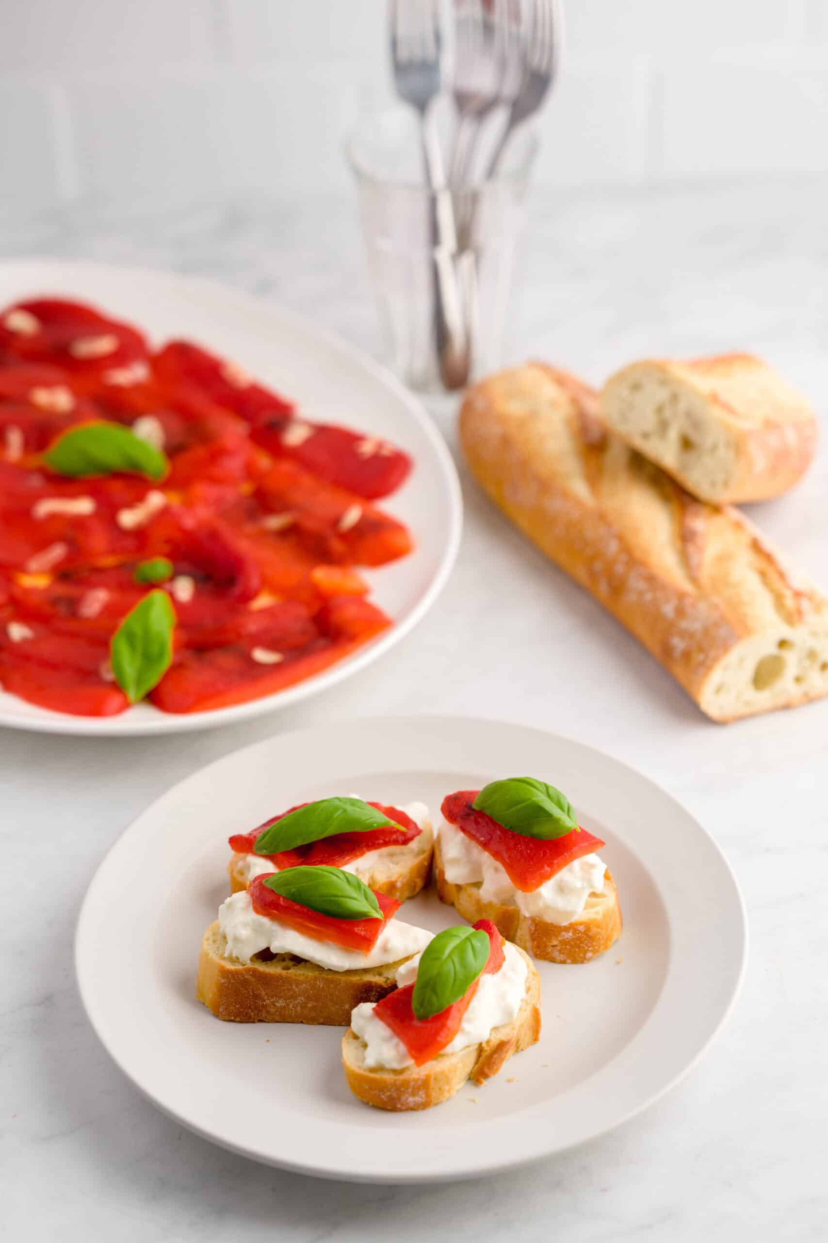 Delicious roasted red peppers with basil on toasted baguette slices.