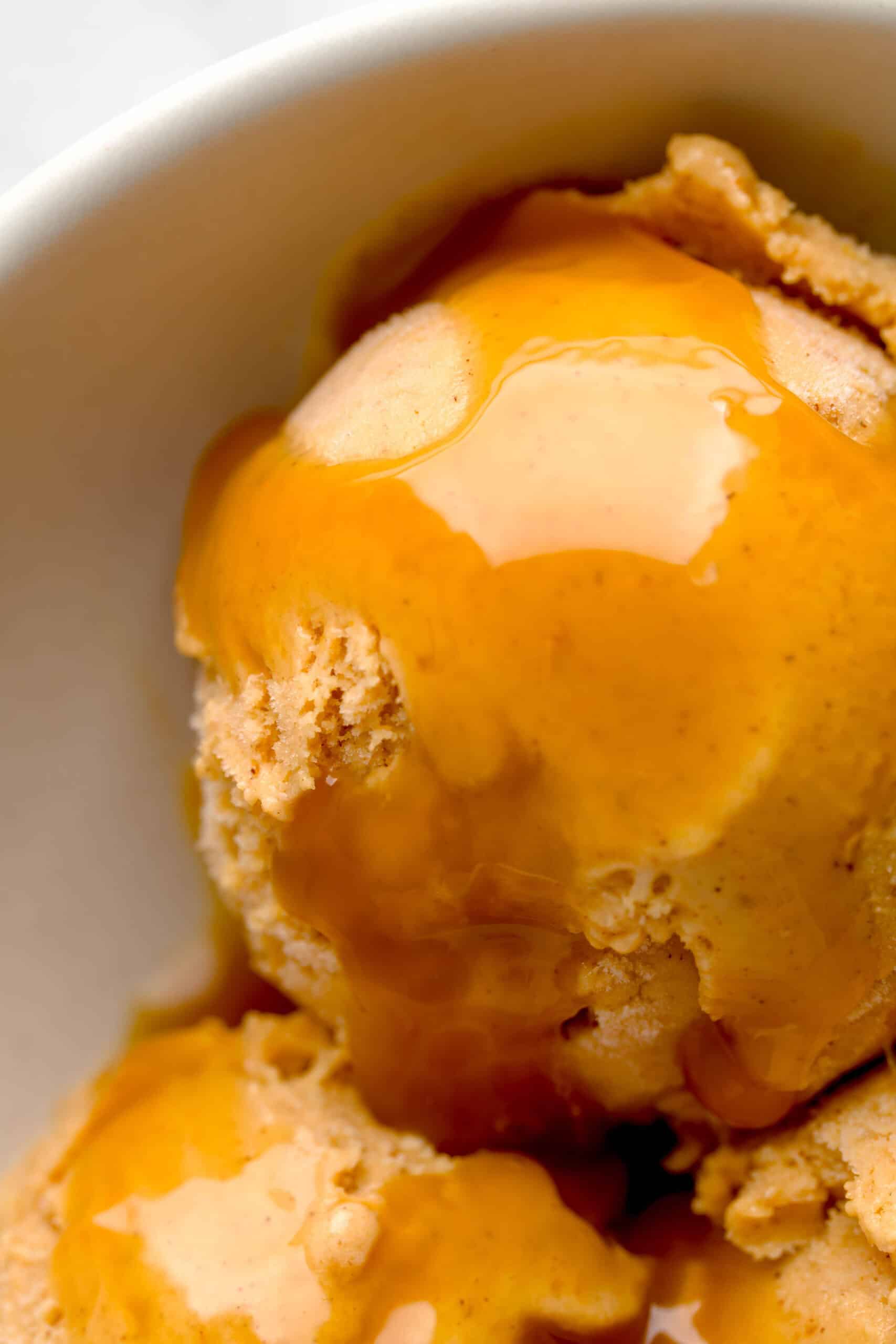 Close up shot of pumpkin spice gelato with caramel sauce.