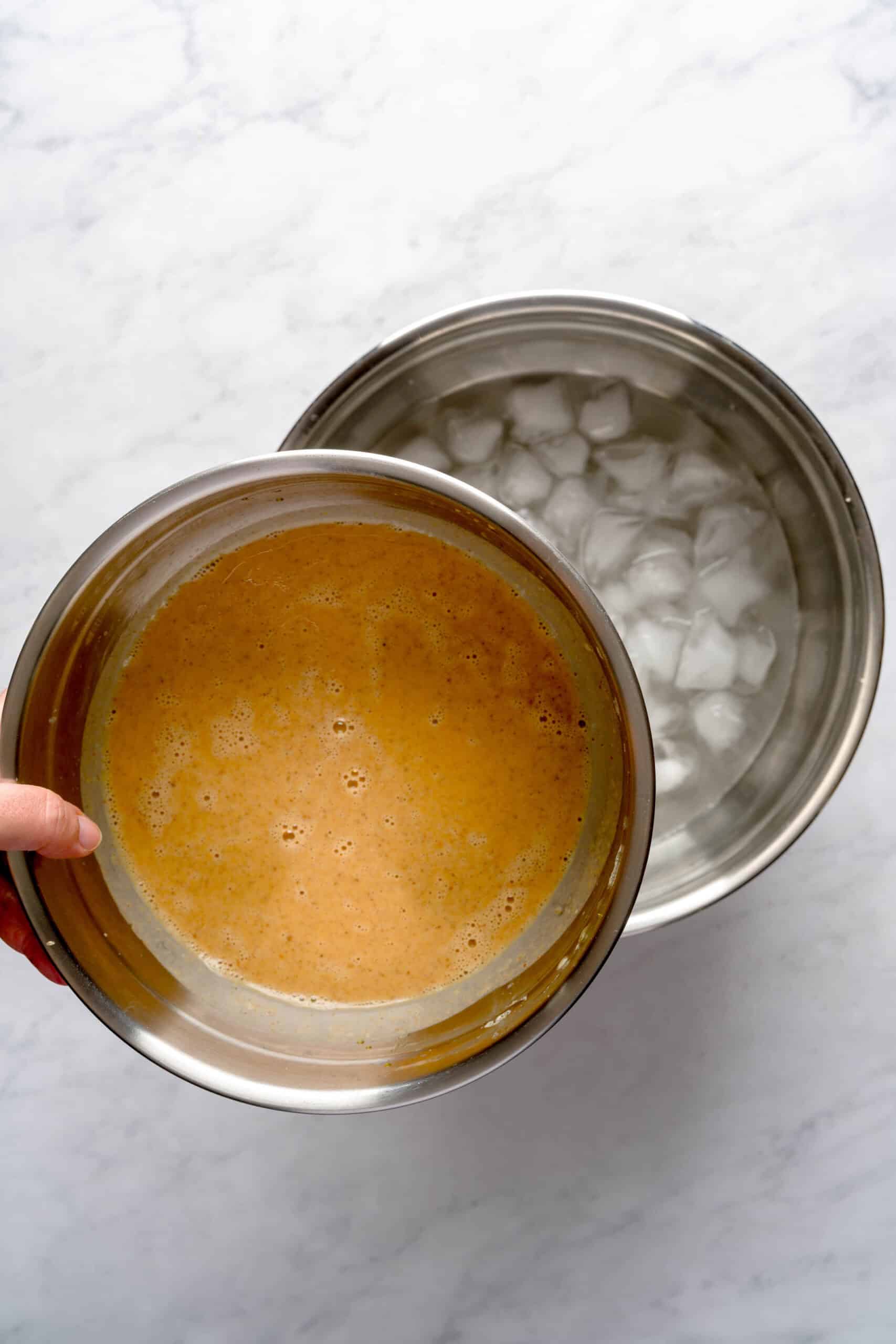 Pumpkin spice gelato base in an ice bath.