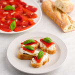 Delicious Italian roasted red peppers with basil on toasted baguette slices.