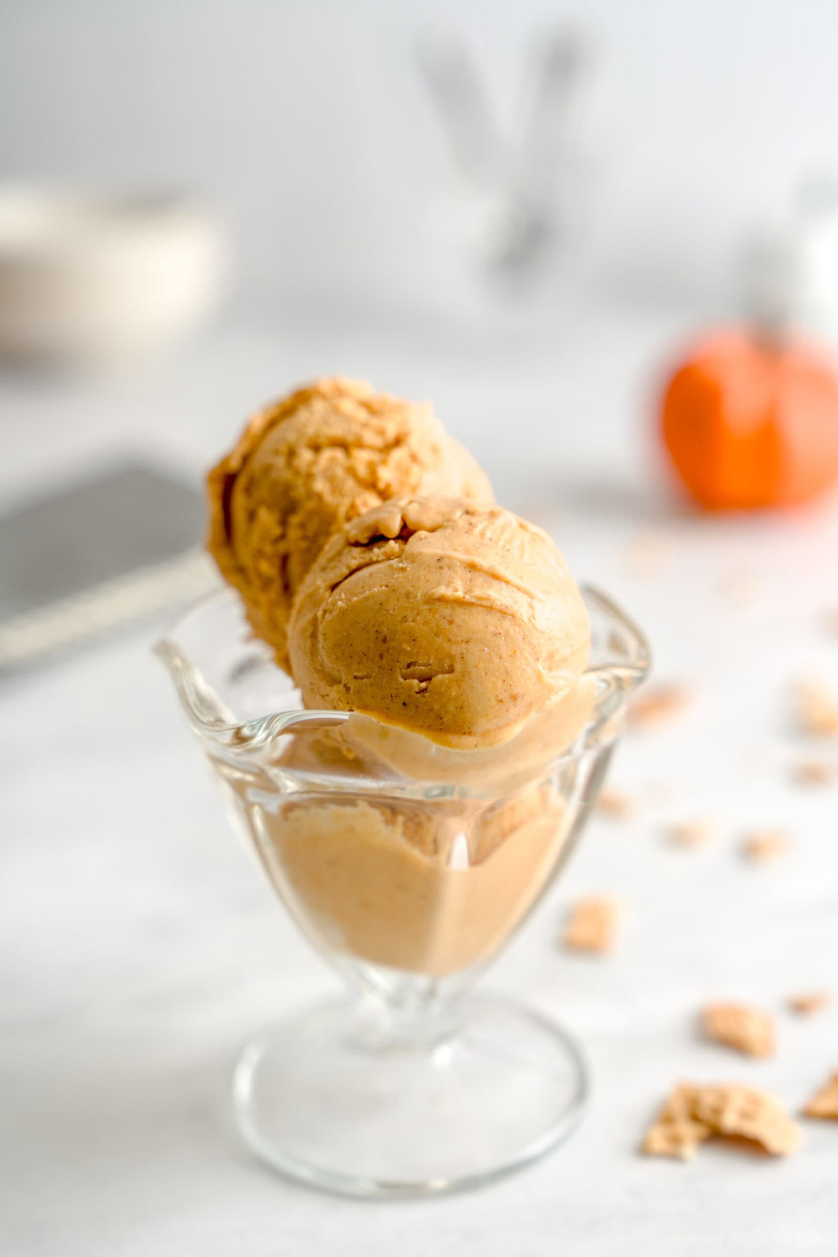 Pumpkin spice pumpkin gelato in a glass ice cream cup.