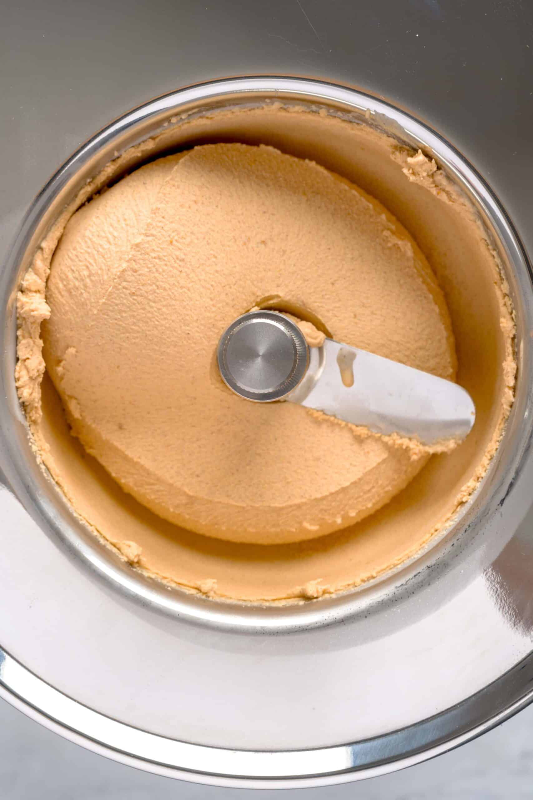 Pumpkin spice gelato ice cream churning in an ice cream maker.
